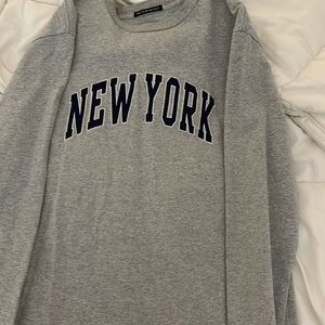 Brandy Melville grey and navy New York sweatshirt.